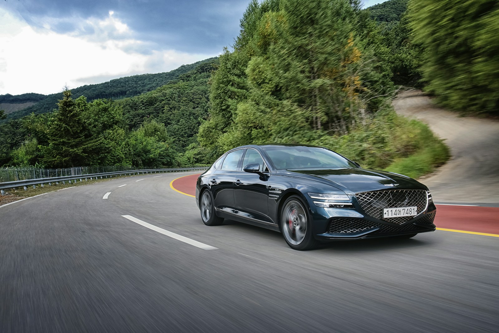 road assistance black car driving down a winding road